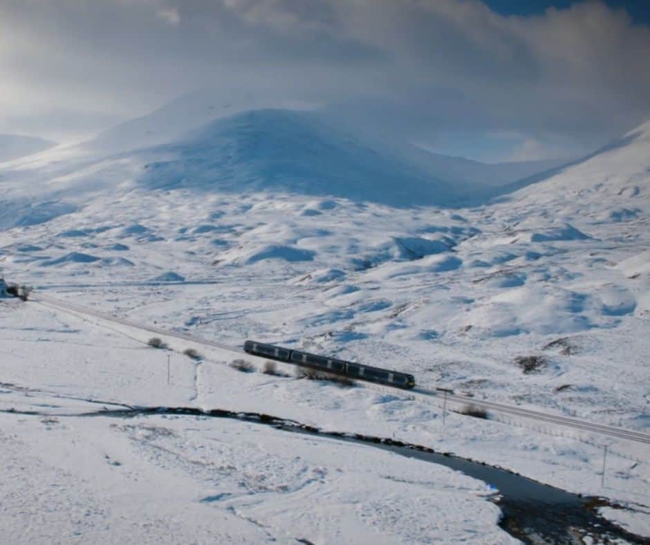 Train In Snow Covered Highlands