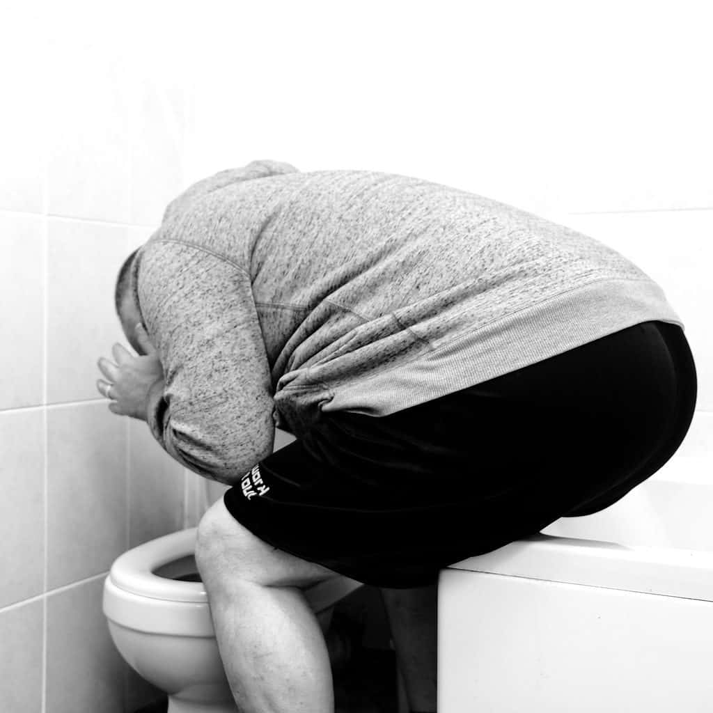 Man Being Sick In The Toilet